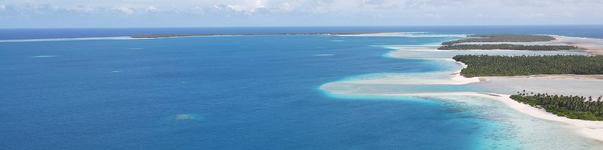 Small, green islands surrounded by turquoise sea.