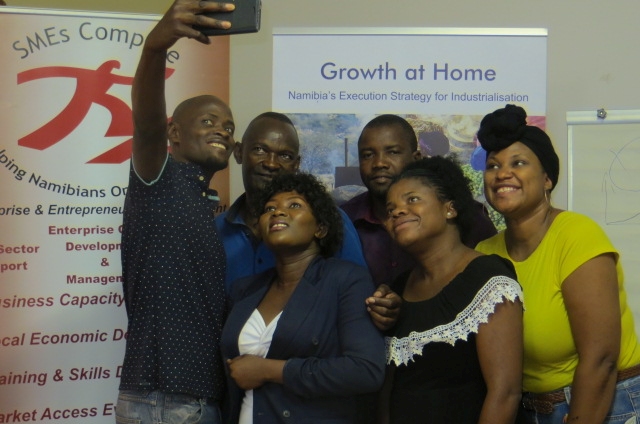 Several participants in an entrepreneurship workshop pose for a photo.