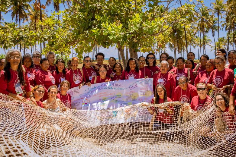 A group of people in red T-shirts and a fishing net.