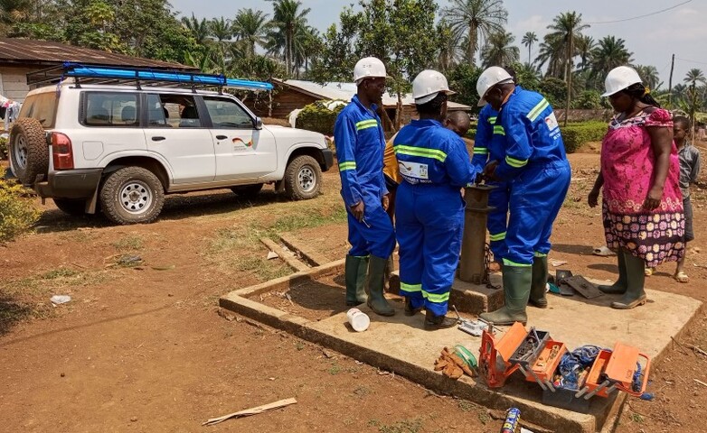 A group of technicians in protective clothing at work.