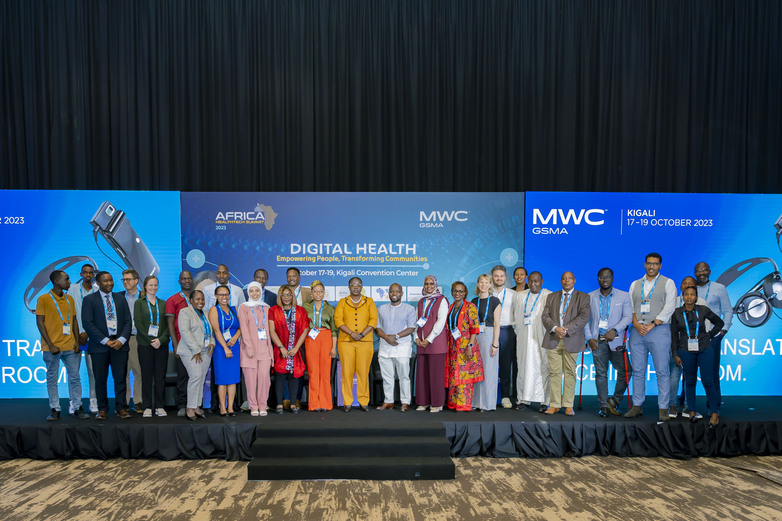 Representatives of the One Digital Health community of practice stand on a stage.