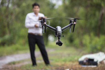 One person controls a drone.