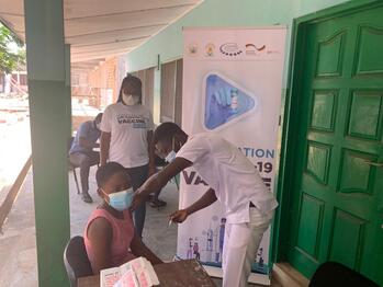 A woman is being vaccinated.