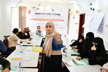 A woman speaks at a workshop in front of representatives of Yemeni non-governmental organisations.