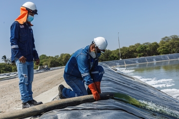Two technicians working at a sewage treatment plant in Piura.