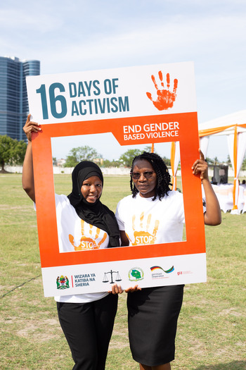 Two students from the Law School of Tanzania hold up a poster for ‘16 Days of Activism’. Copyright: GIZ Tanzania
