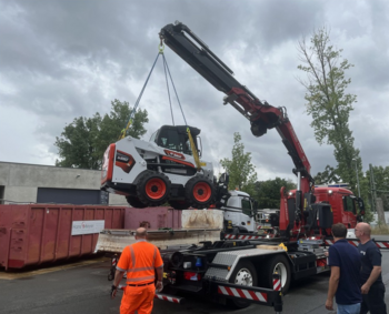 A compact loader being loaded on to a lorry for shipping to Ukraine. 