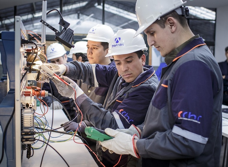 Trainees work on cable connections at a training centre for solar engineers