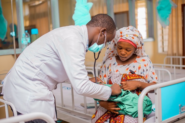 A paediatrician examines a newborn baby in a Tanzanian hospital.
