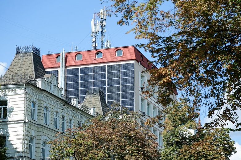 Solar panels have been installed on the side of a building.