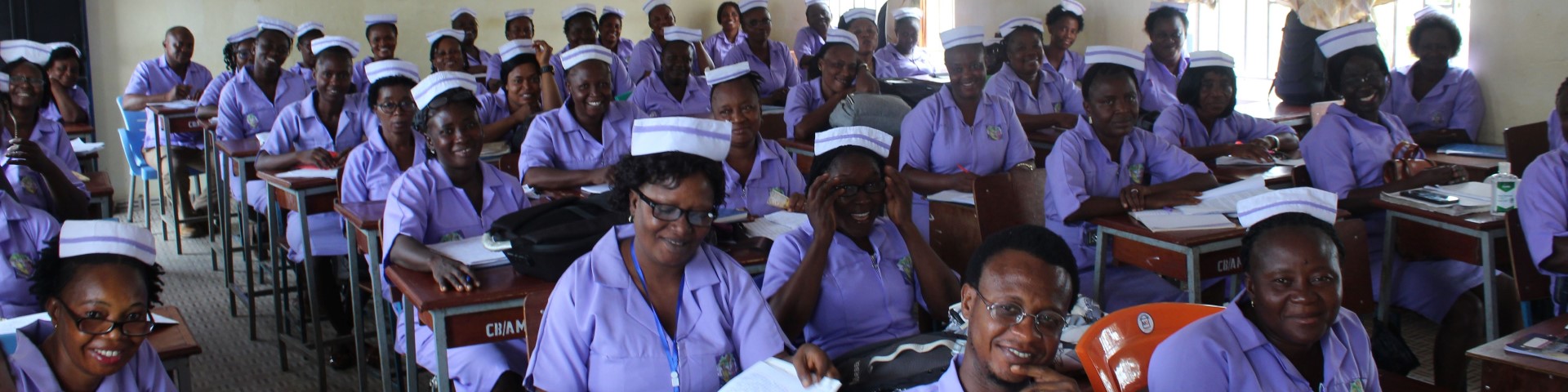 Healthcare workers sit in a classroom during a training session.