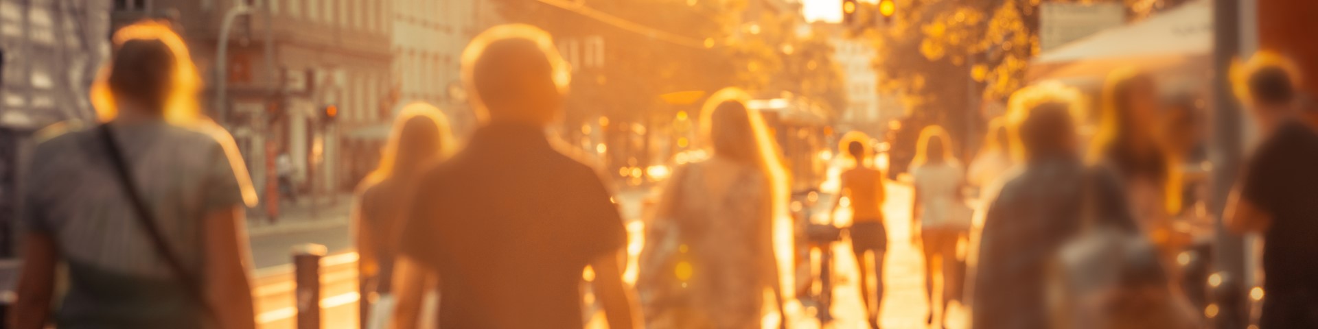 Several blurred people walking along a sunny street in Berlin. Nikada/iStock