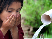Pakistan. Young girl drinking water
