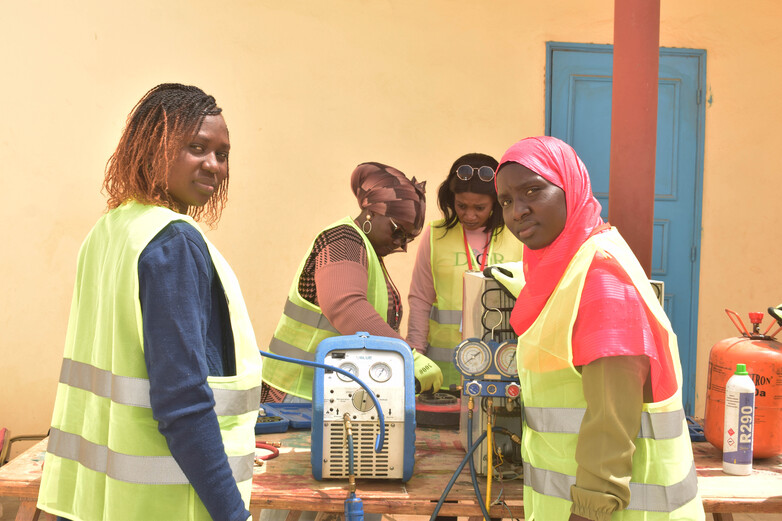 Four women work on cooling technology.