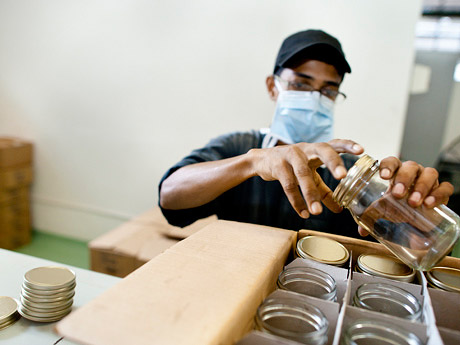 Quality control: An employee checks the jars before they are sent to the bottling plant. 