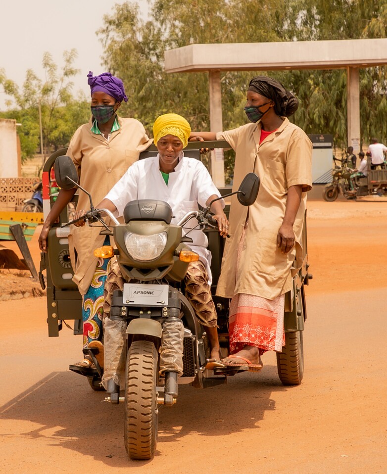 Women driving a motorcycle taxi.