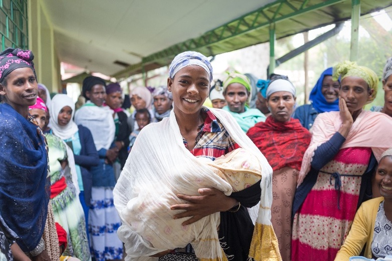 A mother with her baby stands surrounded by a group of women in Butajira in rural Ethiopia.