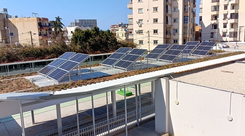 Solar panels are installed on the roof of a school building.