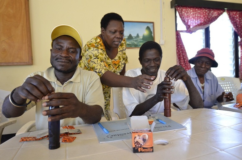Men in Tanzania learn how contraception with condoms works. 