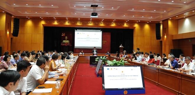Man doing a presentation in front of a group of people sitting at tables