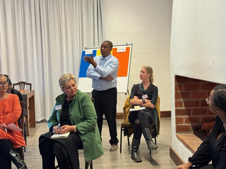 People sitting listening to a man speak