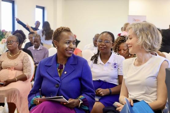 People sitting, 2 women talking to each other