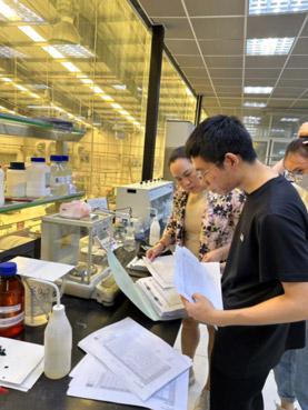 Group of people checking papers in a factory