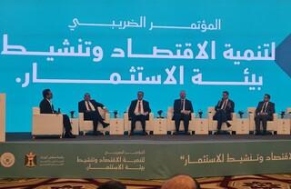 People sitting next to each other on a stage.