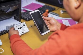 Eine Person hält ein Telefon.