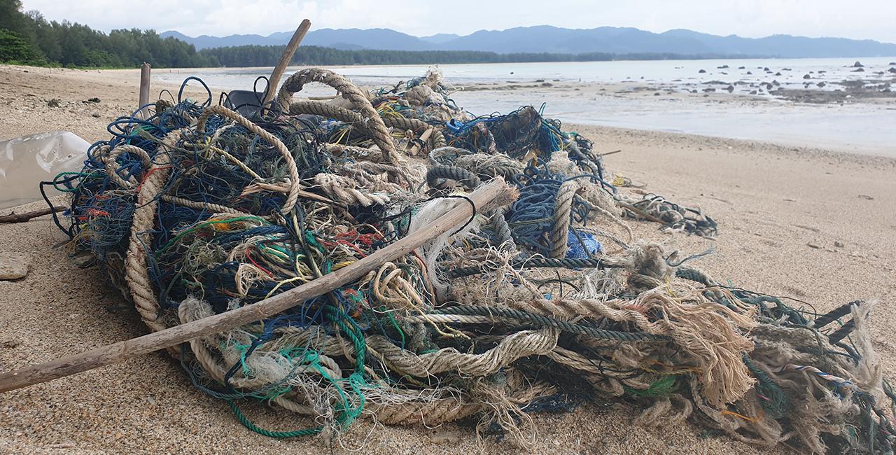 Ship waste consisting of old ropes and nets pollutes a beach