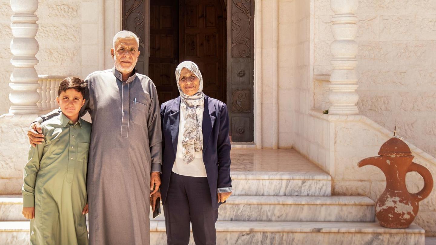 Aida Al Khattab with her husband and grandson