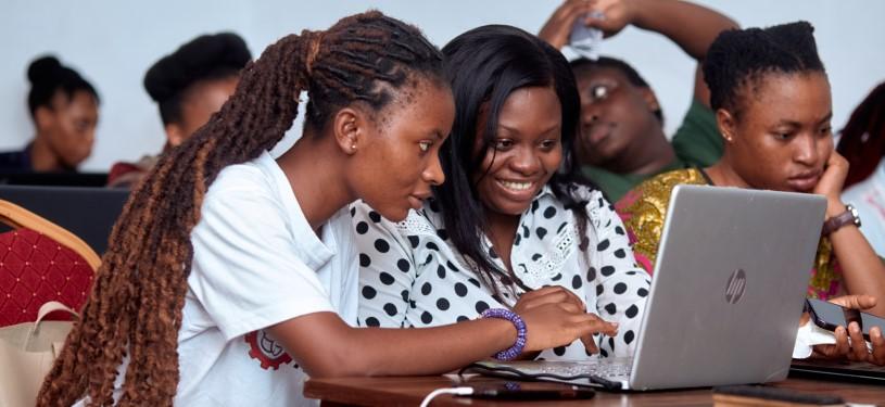Young women sitting in front of a laptop