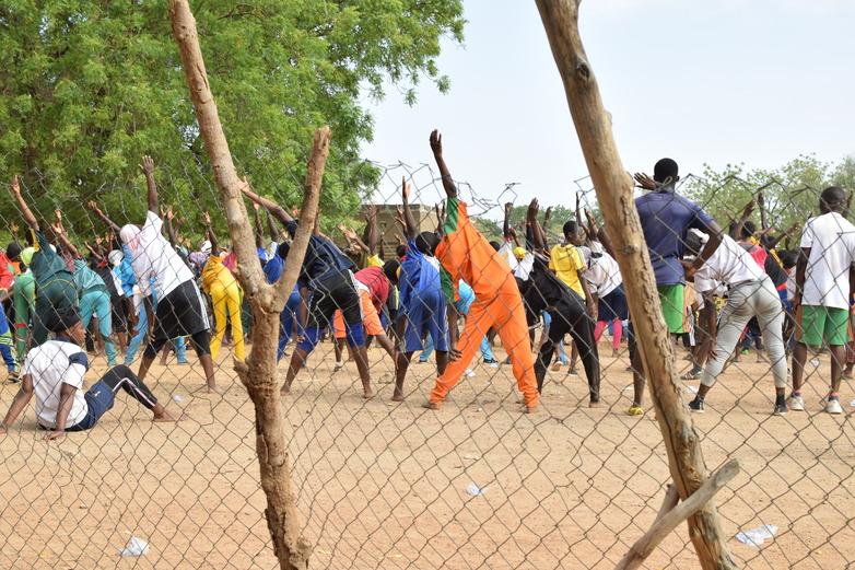 A large group of students exercising outdoors.