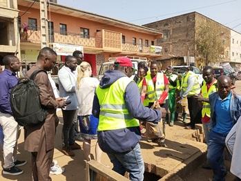 Un groupe de personnes rassemblées autour d’une fosse sont activement impliquées dans l’activité.