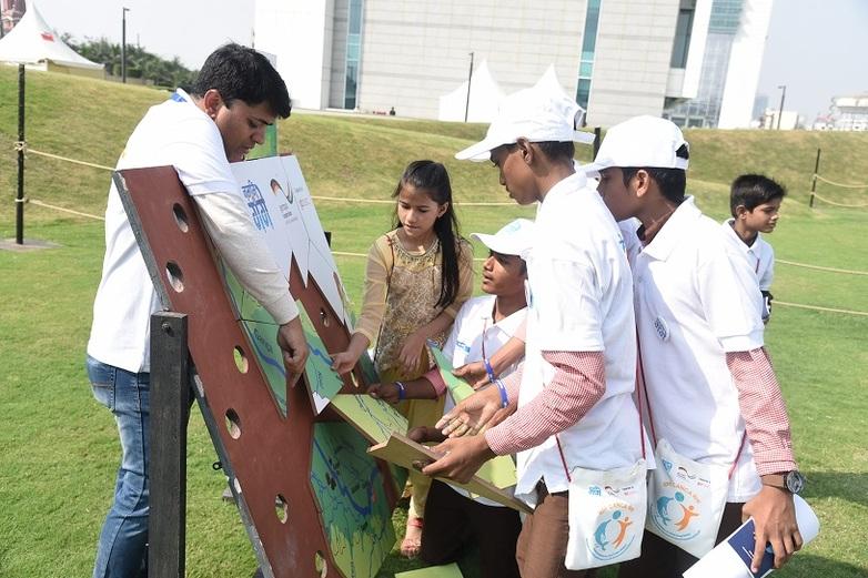 Awareness campaigns on Ganga rejuvenation at the annually celebrated Ganga Utsav (Ganga Day) on 4 November (children playing a puzzle about the Ganga Basin).