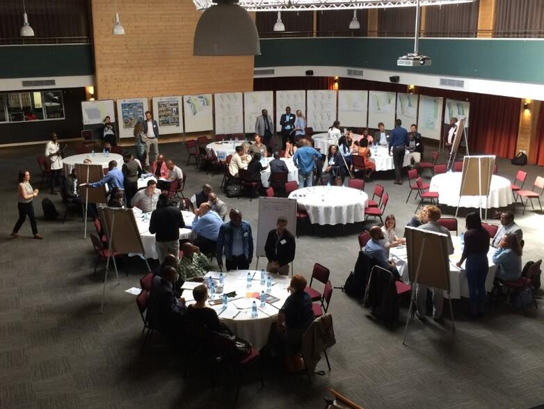 People work together at round tables at a workshop in Namibia. © GIZ MARISMA / Linda Kasheeta