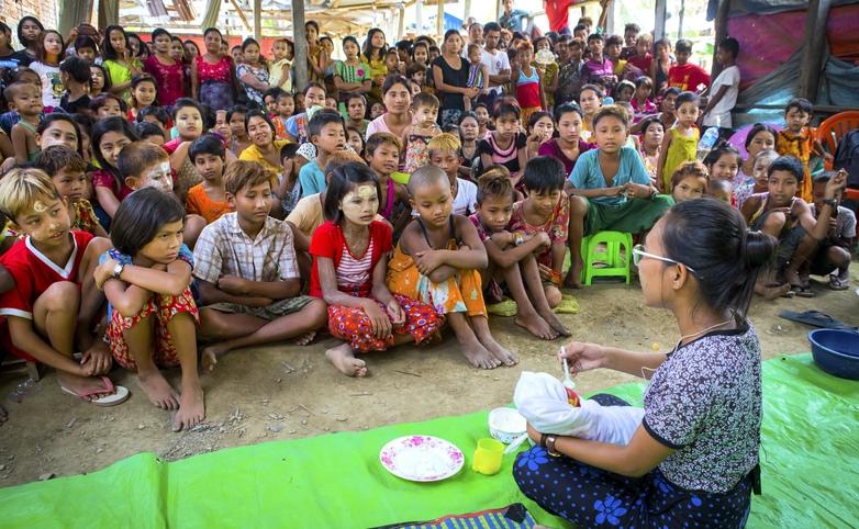 A woman in Myanmar is performing in a community theater play titled "Food Taboos in the First 1,000 Days of Childhood Nutrition”.