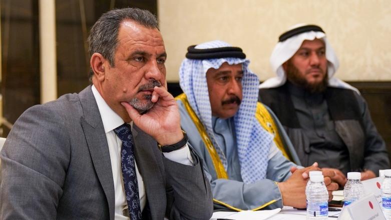 Local peace actors sitting at a table, receiving training on conflict identification, analysis and management.