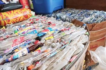 Large bundles of flattened plastic bottles