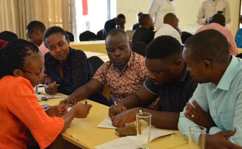 People sitting together at a table and taking notes
