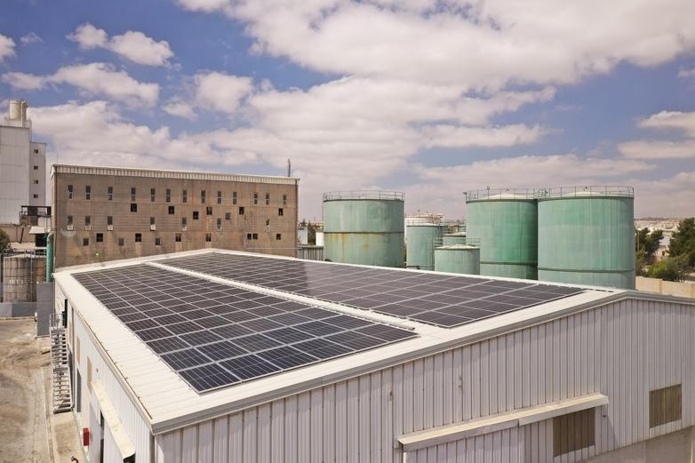 Photovoltaic installation on the roof of an industrial building in Jordan.