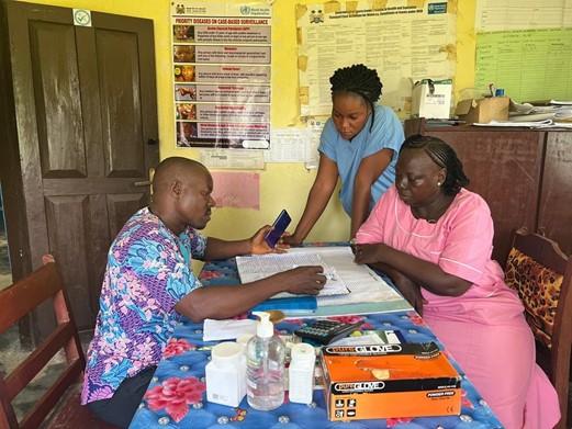 Health care staff sit together and check documents.