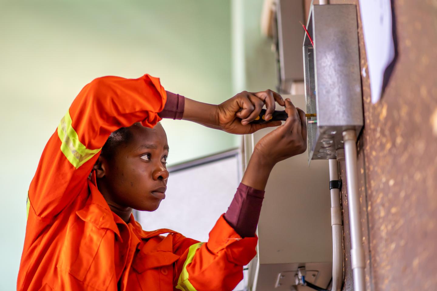 A budding solar electrician works at a vocational school in Zambia.