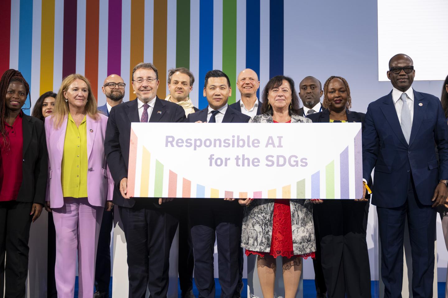 Vertreter*innen des BMZ und des Entwicklungsprogramms der Vereinten Nationen halten auf einer Bühne das Schild „Responsible AI for the SDGs“.