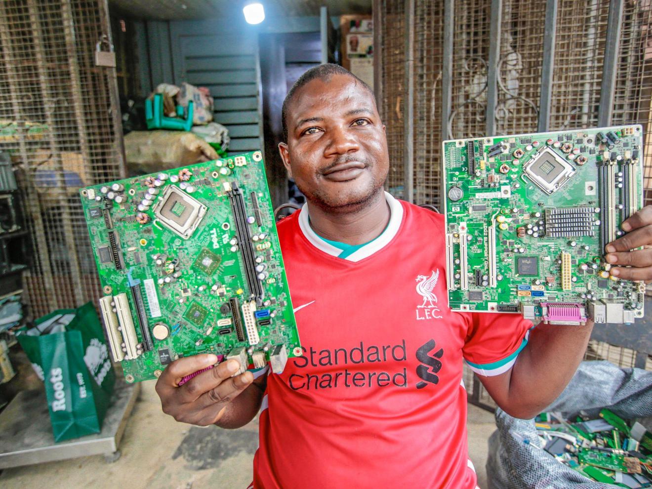 Man holding two circuit boards in his hand