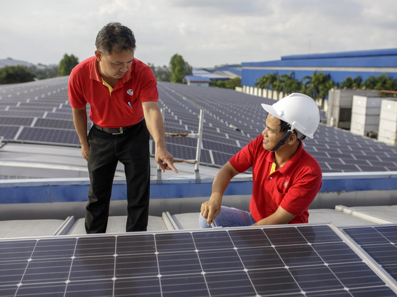 Zwei Solartechniker arbeiten an PV-Panelen.