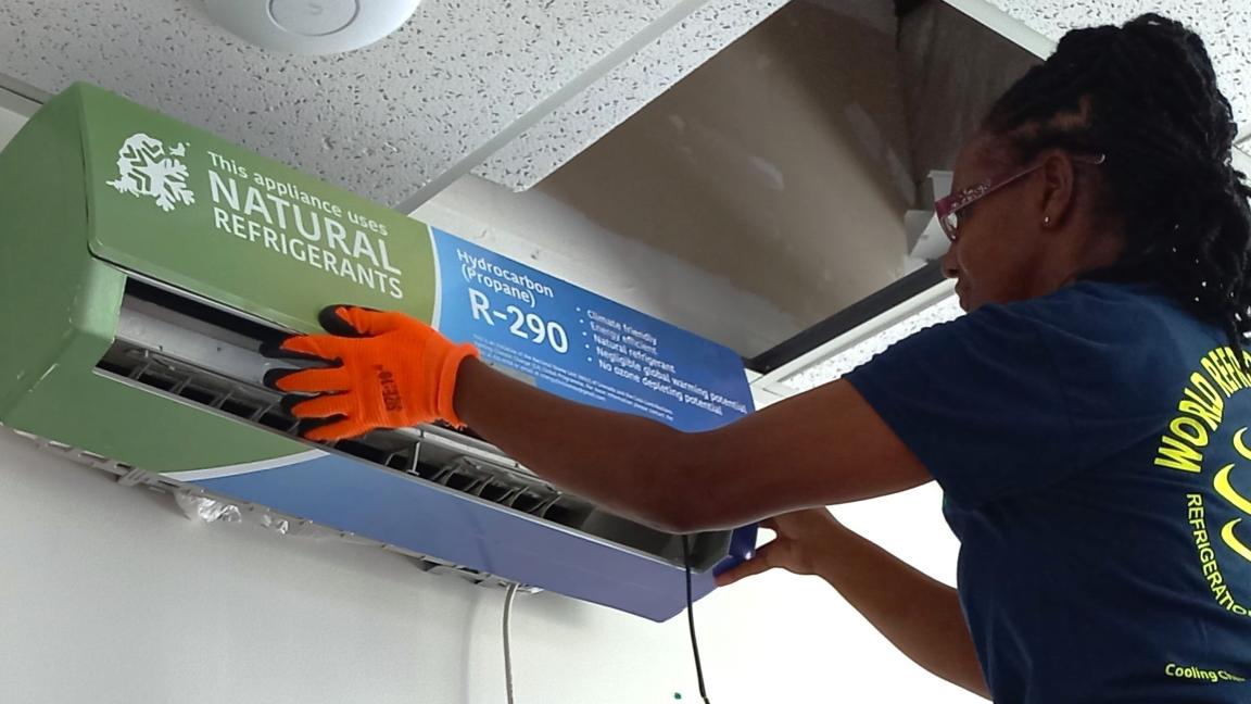 A woman installs an air conditioning system