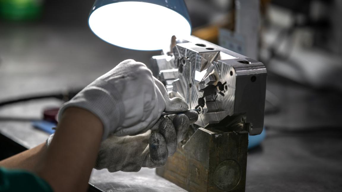 Worker inspecting a mold for plastic products at An Phu Viet Plastics The project "Initiative for Global Solidarity (IGS)" supports producers in selected sourcing markets for electronics and T&G products to fulfill the inc