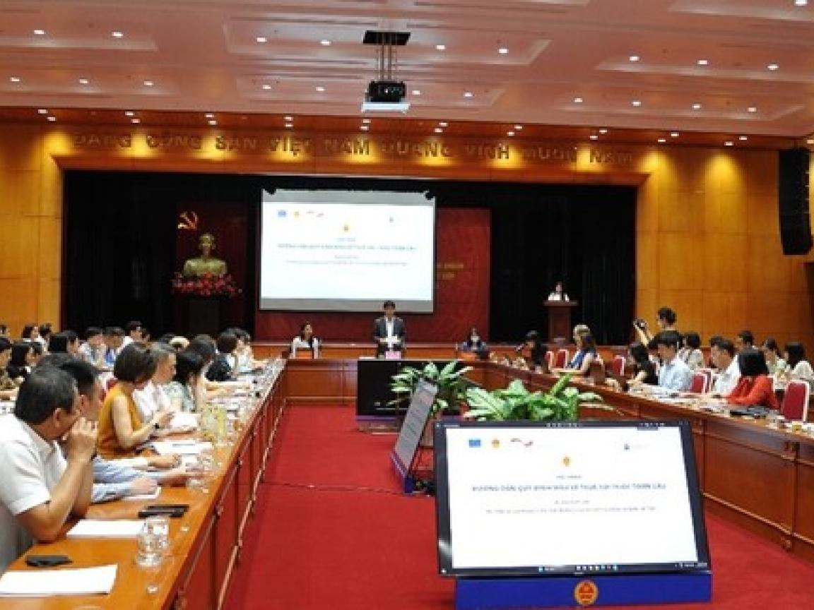 Man doing a presentation in front of a group of people sitting at tables