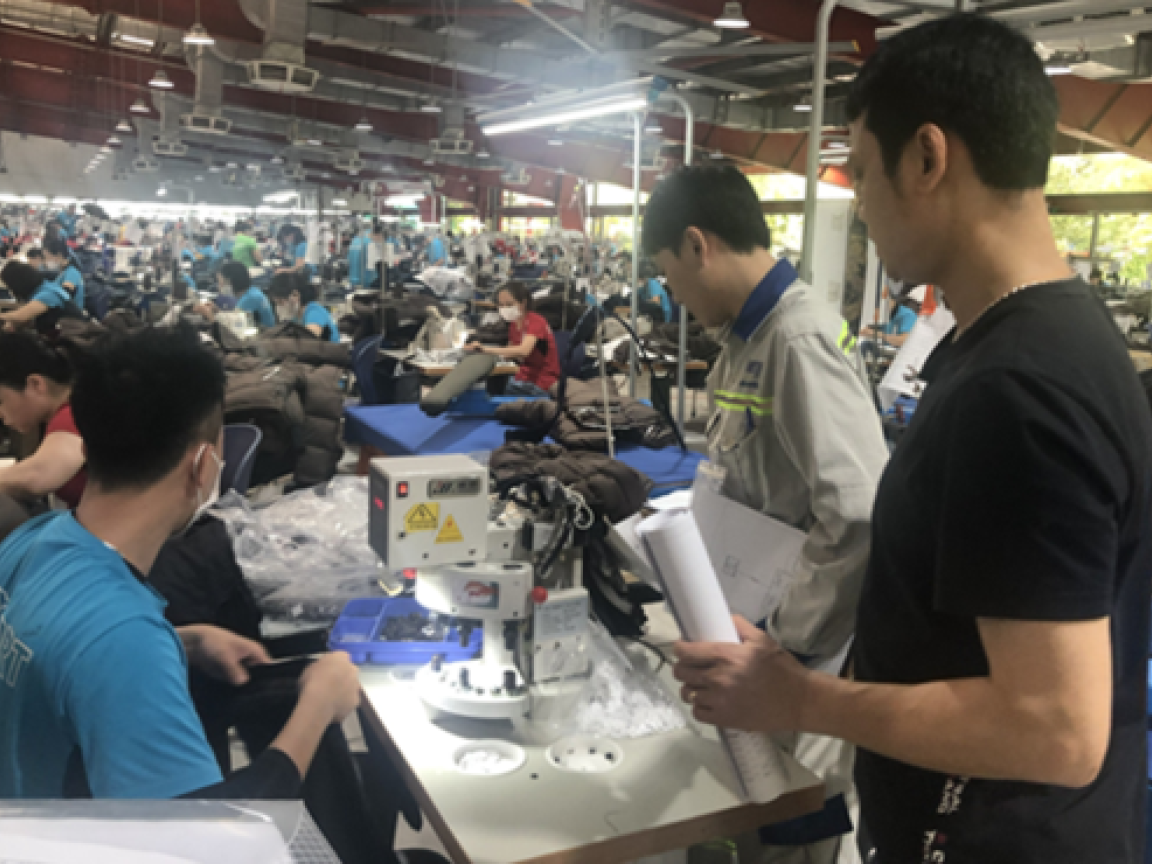 People working in a clothing warehouse